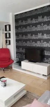 The living room before, with patterned wallpaper