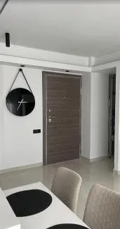Dining area with a wall clock and the entrance door