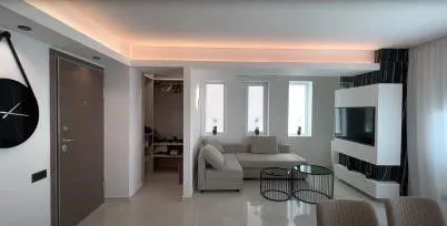 Open living space with a lit ceiling
